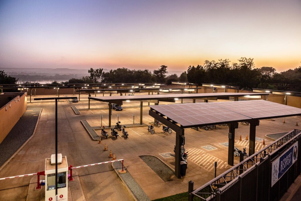 View of embassy parking lot with solar arrays.